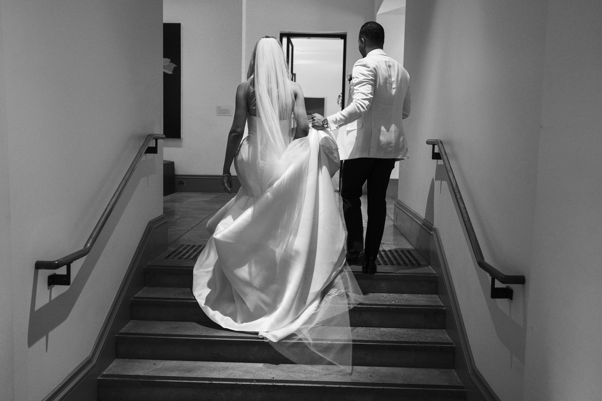 Walking up stairs Bride and groom at Como Treasury