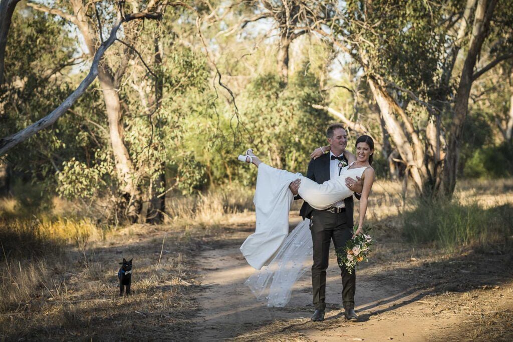 groom and bride with their cat on a walk