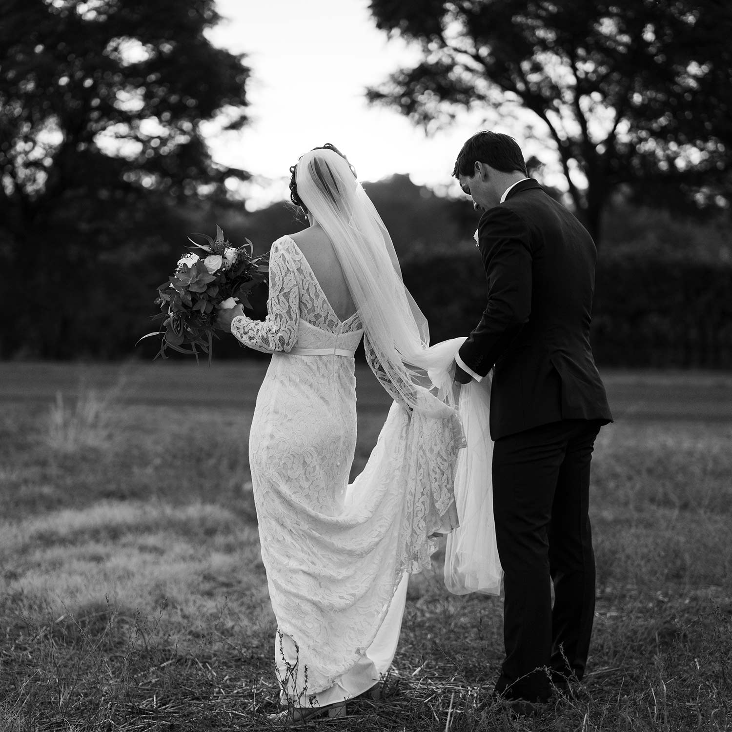 Sittella Winery wedding bride with groom holding her dress