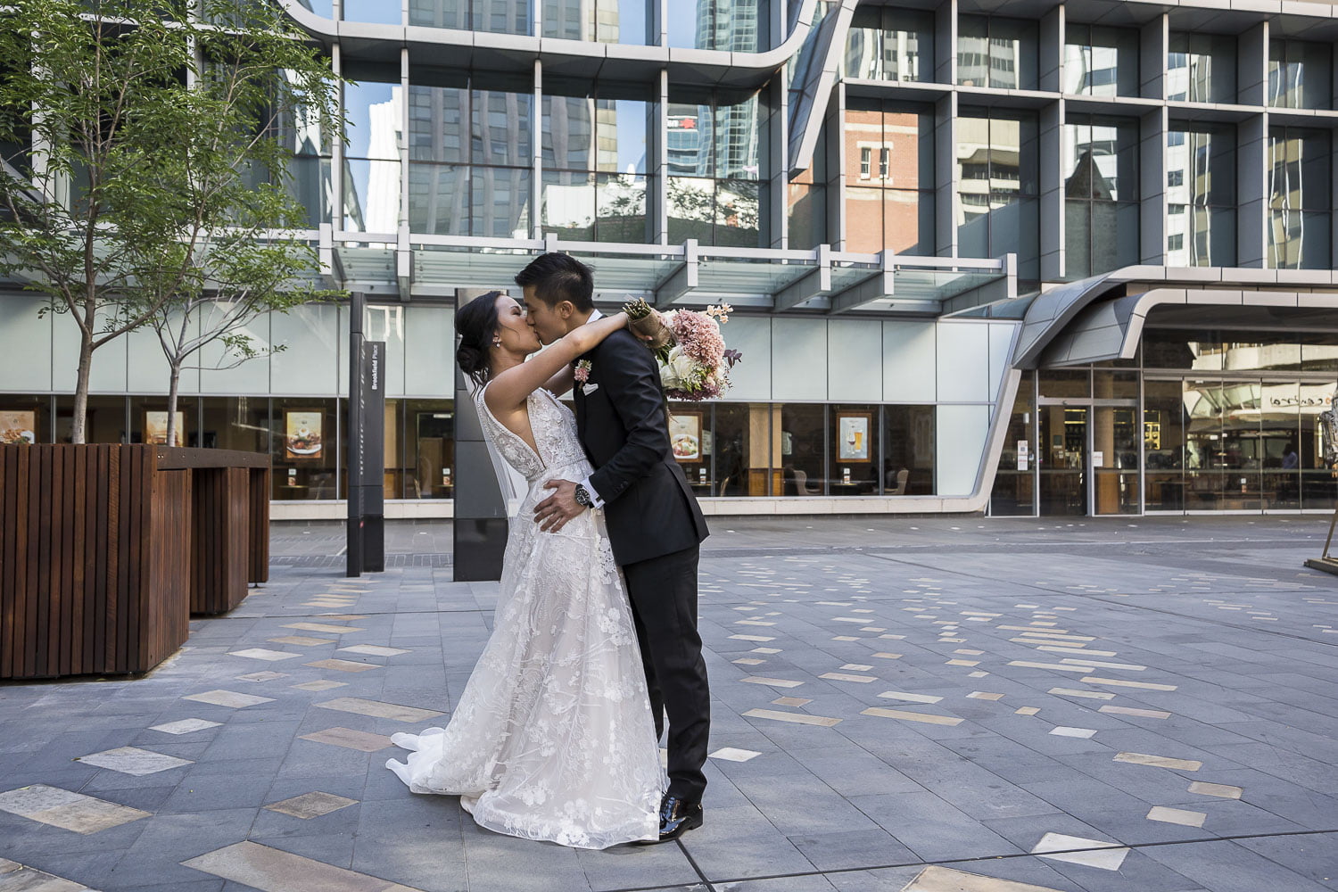 bride with groom kissing Perth